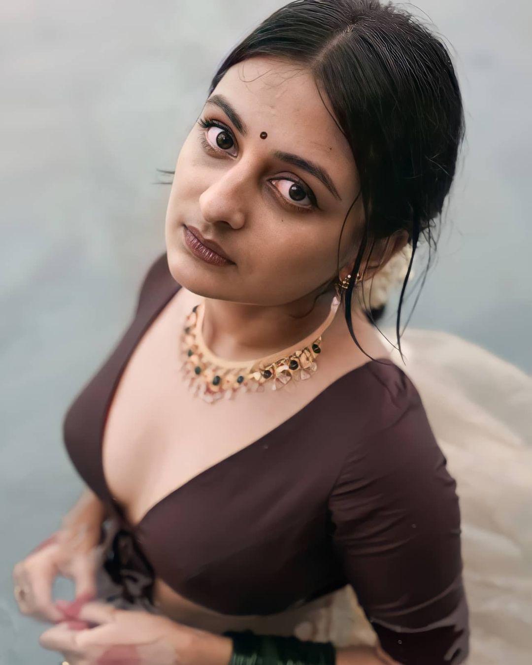 Esther anil wearing Skirt and blouse photos | Esther anil exposing cleavage hot photos