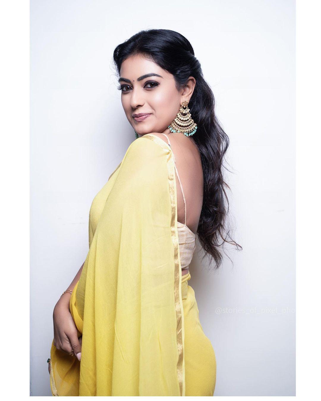 Beautiful and glamours picture | Sonika gowda in sleeveless blouse with yellow transparent saree hot photos