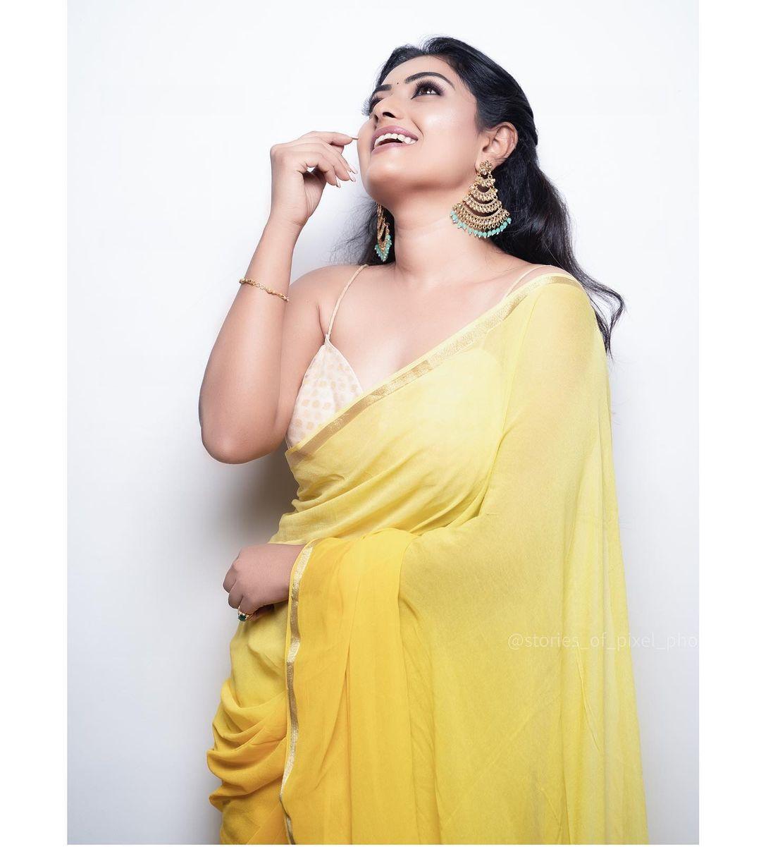 Glamours and cute stills | Sonika gowda in sleeveless blouse with yellow transparent saree hot photos