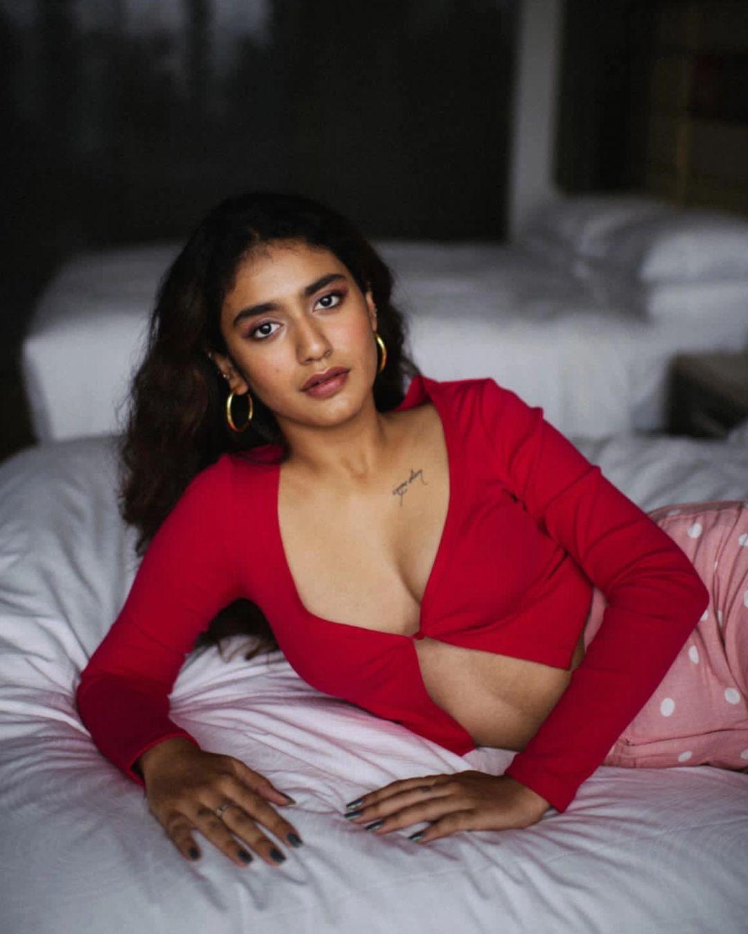 Looking very glamours and cute stills | Priya Prakash Varrier exposing Cleavage hot photos in bedroom