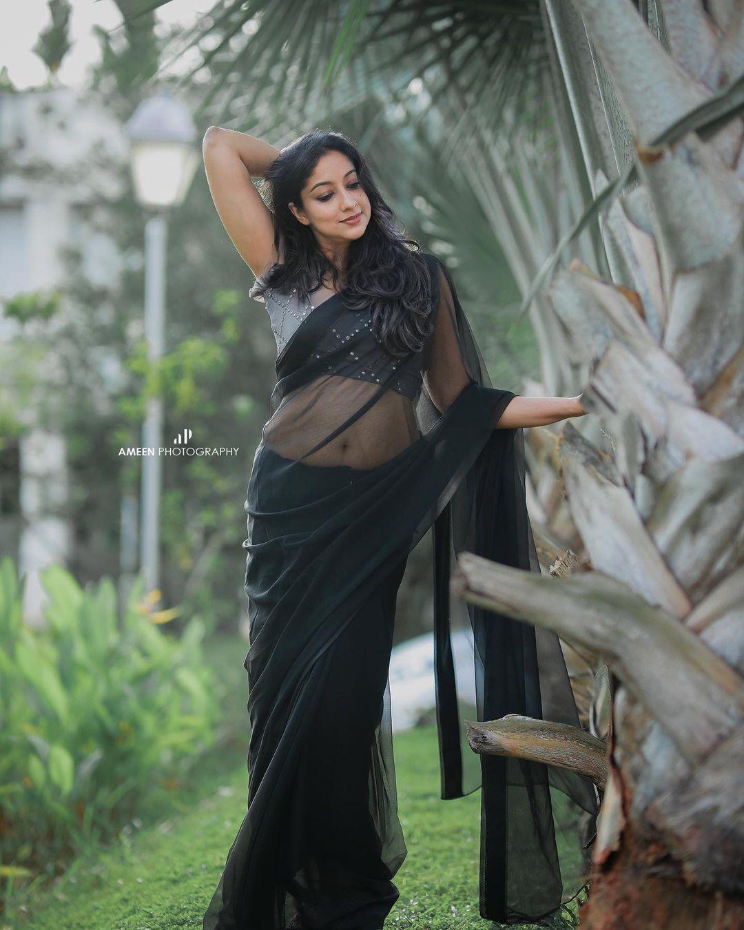 Glamorous and cute stills | Laya Simpson in black transparent saree hot photos gallery