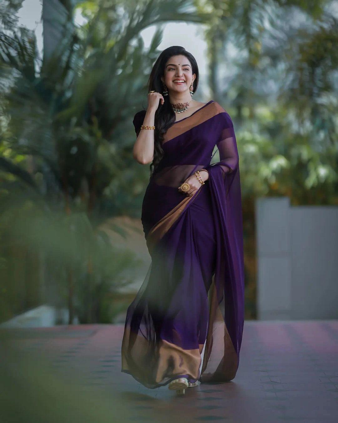 Beautiful and sexy stills | Honey Rose in violet transparent saree hot photos gallery