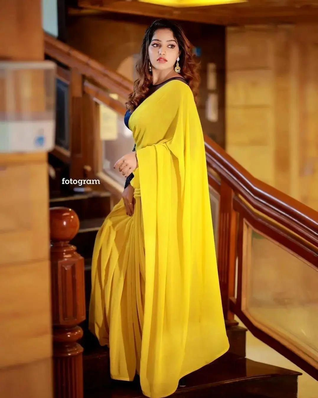 Glamorous and cute stills | Malavika Menon in yellow transparent saree hot and sexy photoshoot