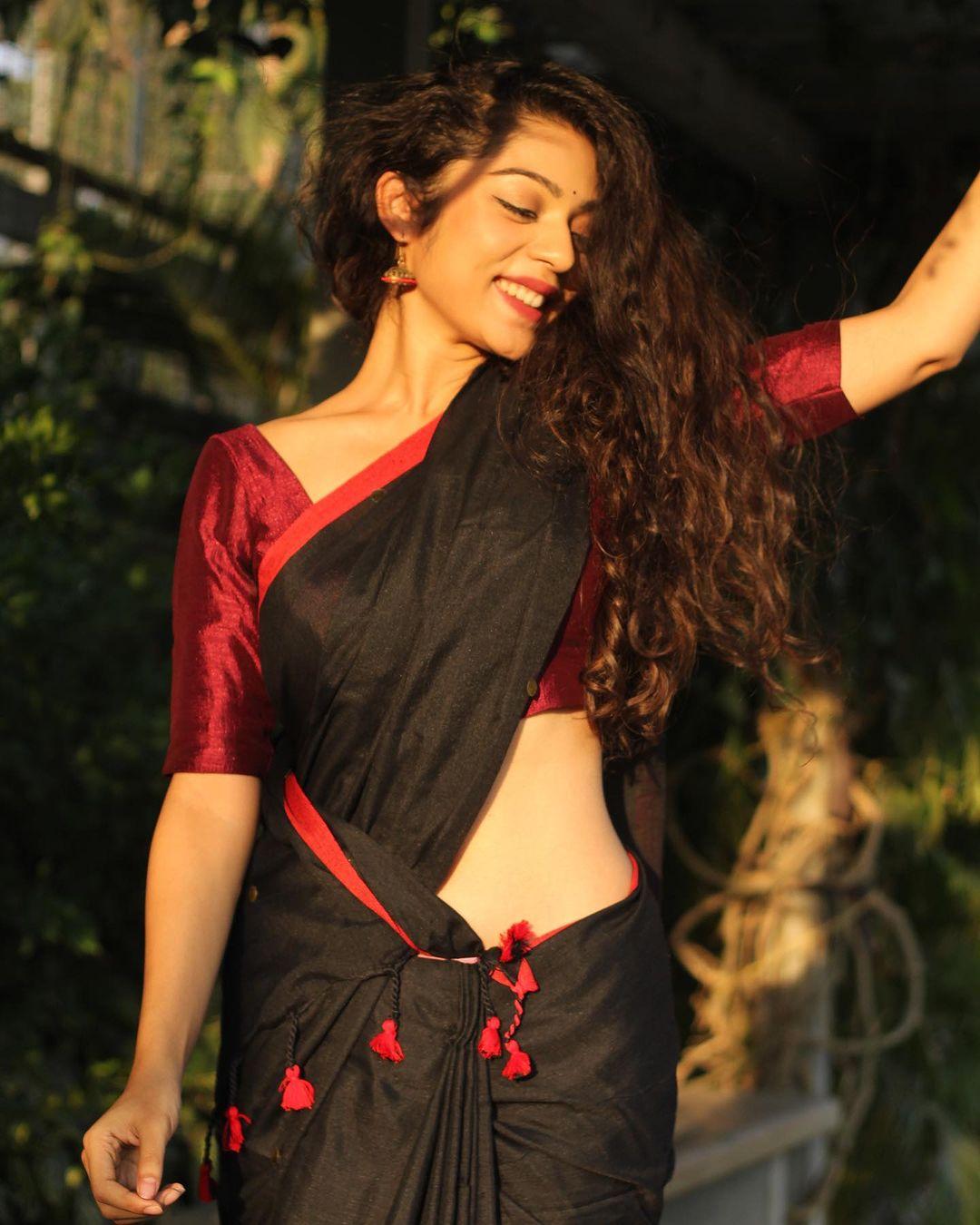 Varsha Bollamma in a black saree exclusive hot photos