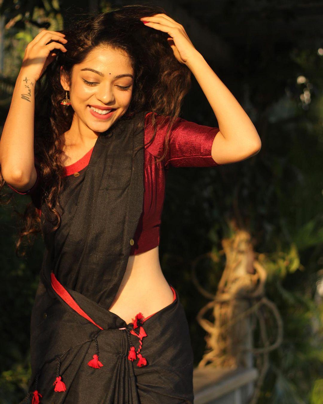 Varsha Bollamma in a black saree exclusive hot photos