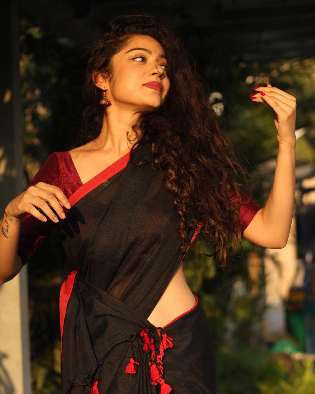 Varsha Bollamma in a black saree exclusive hot photos